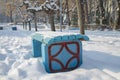 Bench is covered with snow in winter in the park Royalty Free Stock Photo