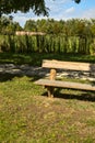 Bench by the edge of a path under two trees in the countryside in autumn Royalty Free Stock Photo