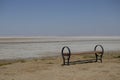 A bench in flat open space. no human.