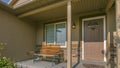 Bench on the front porch of a home on a sunny day Royalty Free Stock Photo