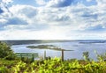 Bench in front of river islands and cloudscape Royalty Free Stock Photo