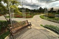 Bench in a garden with flowers and arbor - nice and neeat outdoor park Royalty Free Stock Photo