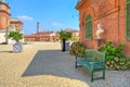 Bench on gravel next to brick house in Piedmont, Italy.