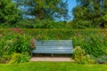 Bench in a green garden at Olveston Historic Home in Dunedin, New Zealand Royalty Free Stock Photo