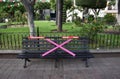 Bench in the hidalgo garden, with wooden sticks for social distancing Royalty Free Stock Photo