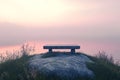Bench is on a hill overlooking a lake Royalty Free Stock Photo