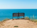 bench on a hill overlooking the sea