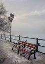 Bench and lantern on foggy winter morning Royalty Free Stock Photo