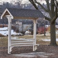 Bench located in park next to river and bridge