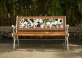 A bench made from wood and metal engraving white coloured photo taken in Semarang Indonesia