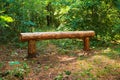 Bench of wooden logs for people in the green forest. National park