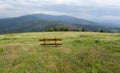 A bench in a meadow in front of the mountain shelter in Hala Rysianka in Beskid Zywiecki in Poland, where you can sit and admire