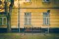 Bench near old yellow house facade Royalty Free Stock Photo