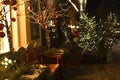 A bench near a shop window on a street decorated with Christmas garlands. Royalty Free Stock Photo