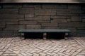 A bench near a stone wall outside Central Park, New York City Royalty Free Stock Photo