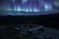 A bench in Norwegian National park with aurora