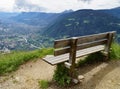 bench overlooking alpine valley of city Merano surrounded by Texel group mountains (Oetztaler Alps, South Tyrol, Italy)