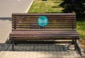 bench in a park with an anti-covid inscription in russian language minimum distance 1.5 meters