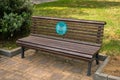 bench in a park with an anti-covid inscription in russian language minimum distance 1.5 meters