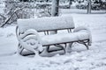 Bench in the park is covered in snow. Winter Royalty Free Stock Photo