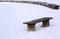 Bench in park covered with snow in winter sunny day. Nature background. Concept of loneliness and sadness. Nobody is walking in Royalty Free Stock Photo