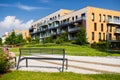 Bench in park with modern block of flats in the background Royalty Free Stock Photo