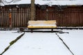 Bench in the park under the snow Royalty Free Stock Photo