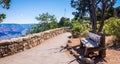 Bench on the path at the Grand Canyon Village. Picturesque overview of the Grand Canyon, Arizona