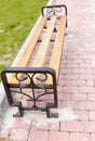 Bench on the pavement in the park Royalty Free Stock Photo