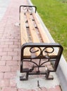 Bench on the pavement in the park Royalty Free Stock Photo