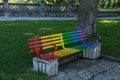 Bench for people to sit on painted with rainbow colors for gay pride day with selective focus Royalty Free Stock Photo