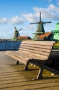 Bench on the pier in Zaanse Schans, Holland, Europe against the Royalty Free Stock Photo