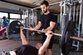 Bench press weightlifting man with personal trainer Royalty Free Stock Photo