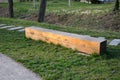 Bench prism of one piece of trunk painted in the park pedal road made of concrete tiles in lawn straight row concrete walkway in c Royalty Free Stock Photo