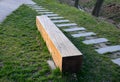 bench prism of one piece trunk painted in the park pedal road made of concrete tiles in lawn straight row concrete walkway in c Royalty Free Stock Photo