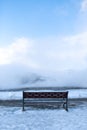 Bench for rest overlooking a cloud of steam in winter