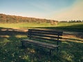 A bench for rest stands in a clearing, around a field and a forest, a picturesque place Royalty Free Stock Photo