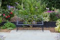 Bench seat on garden patio with flowers