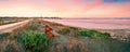 Bench on shore of salt lake of Aliki with Hala Sultan Tekke mosque in background Royalty Free Stock Photo