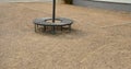 Bench sitting round with wood paneling gray metal plate three seats around a tree around a gravel threshing path in the park lawn