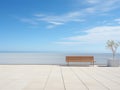 a bench sitting on a tiled patio overlooking the ocean Royalty Free Stock Photo