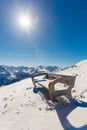 Bench in ski resort Bad Gastein in winter snowy mountains, Austria, Land Salzburg Royalty Free Stock Photo