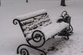 a bench in the snow in the park