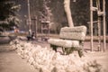 Bench with snow after snowstorm or in snow calamity in europe, winter night photograhy in city Royalty Free Stock Photo