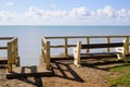 Bench at the top of the stairs pedestrian access to the sand of the beach