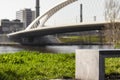 Bench with the Troja bridge in the blurred background in Prague during the daytime