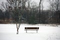 Bench under snow in Michigan cold winter lonely sad Royalty Free Stock Photo