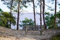 Bench under tree with lake view on sand hill Royalty Free Stock Photo