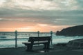 Bench with view of the beach on the north Cornish coast near Bude, England after sunset Royalty Free Stock Photo