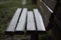 Bench in the village after the first snow, the end of autumn and the beginning of winter Royalty Free Stock Photo